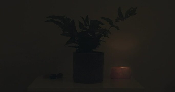 Bedside table at night with Rose Quartz candle
