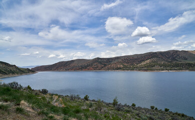 Scenic view of California Lake in the mountains in summer with blue skies and puffy white clouds	
