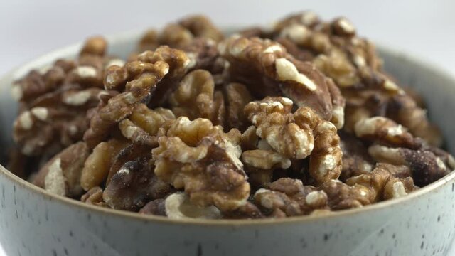 Rotating Bowl Of Walnuts. Spinning Nuts. Protein Plant Based Raw Vegan Food. Health And Vegetarian Foods. Healthy Breakfast Ingredients. Macro 4K Shot