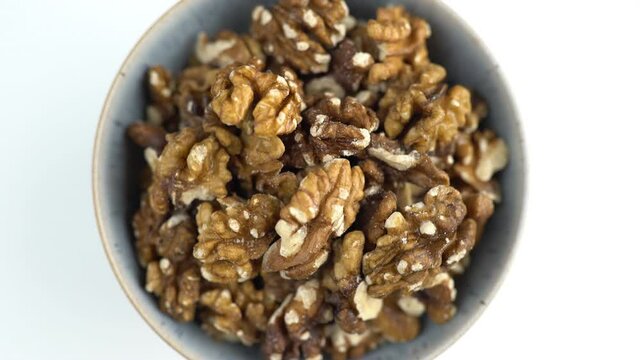 Bowl Of Walnuts Shot From Above. Spinning Nuts. Protein Plant Based Raw Vegan Food. Health And Vegetarian Foods. Healthy Breakfast Ingredients. Macro 4K Shot Of Nutritional Ingredients.