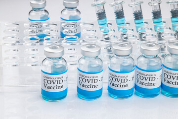 Glass vials labelled with COVID-19 .