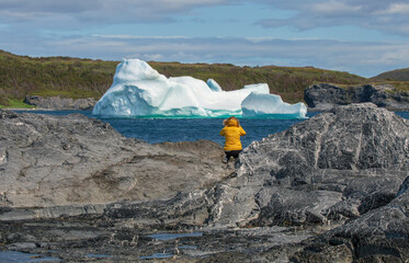 Female tourist photographing iceberg