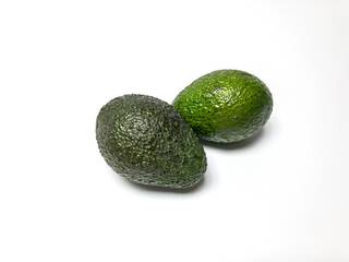 two avocados isolated on white background