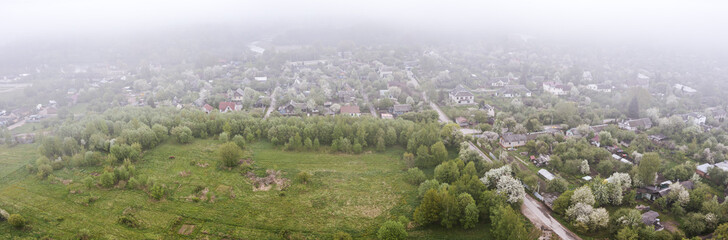 aerial cityscape of residential districts and suburbs of the Minsk city, Belarus, on a foggy summer day