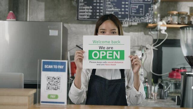 We Are Open And Keep Social Distance With Using Face Mask To Avoid Coronavirus Spread Out, Asian Entrepreneurs Show Display To Aware Her Customer.