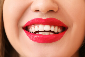 Fototapeta premium Beautiful young woman with bright lipstick, closeup