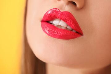 Fototapeta premium Beautiful young woman with bright lipstick, closeup