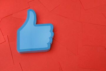 Thumb up sign isolated on red papers 