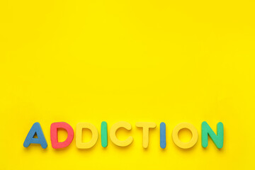 Word ADDICTION on color background