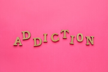 Word ADDICTION on color background