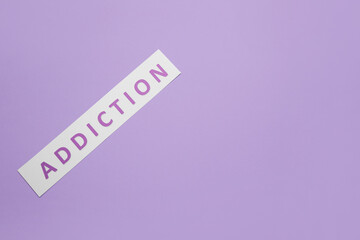 Word ADDICTION on color background
