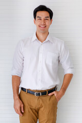 Portrait shot of young adult Asian confident man model in black hairstyle wearing a formal white...