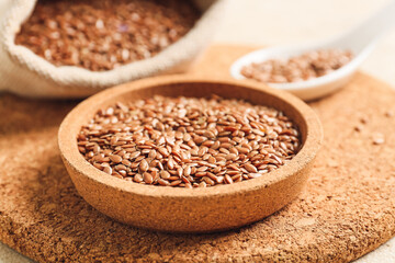 Bowl with flax seeds on table, closeup