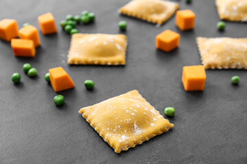 Raw ravioli on dark background