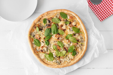 Delicious vegetarian pizza on white wooden background