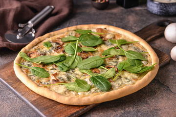 Delicious vegetarian pizza with spinach on grunge background