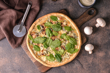 Delicious vegetarian pizza with spinach on grunge background