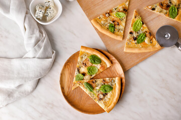 Plate with slices of tasty vegetarian pizza on wooden table