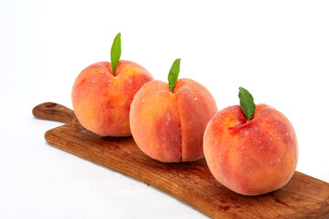 Fresh peaches and leaves