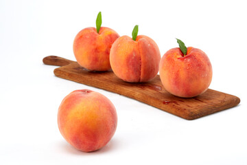 Fresh peaches and leaves