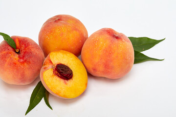Fototapeta na wymiar Fresh peaches and leaves
