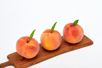 Fresh peaches and leaves