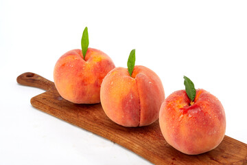 Fresh peaches and leaves