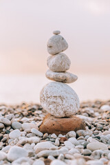 Fototapeta na wymiar Balance stones on the beach at sunrise