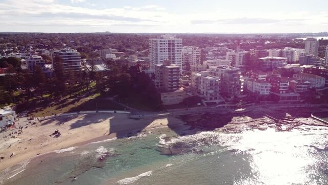 Cronulla and Beach Sydney Australia Backwards Aerial from North to South Cronulla Beach over Rock Pools and Clear Turquoise Ocean on a Sunny afternoon