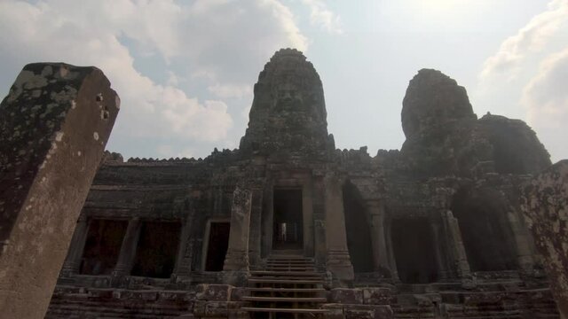 Wide dolly shot moving through a doorway to reveal the ancient temple located in Angkor Wat Cambodia.