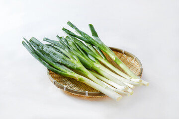 White background, green onions, vegetables.