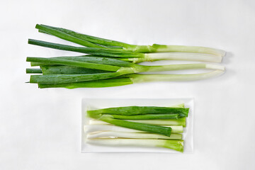 White background, green onions, vegetables.