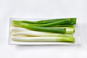 White background, green onions, vegetables.