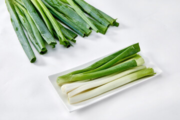 White background, green onions, vegetables.