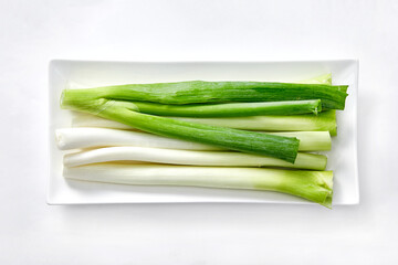 White background, green onions, vegetables.