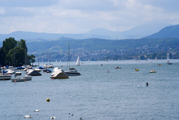 Fototapeta na wymiar Lake Zurich on a beautiful windy summer day with sailing and motor boats. Photo taken June 13th, 2021, Zurich, Switzerland.