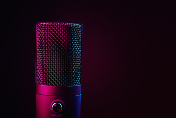 Studio microphone on dark background with copy space. Black professional condencer microphone with...