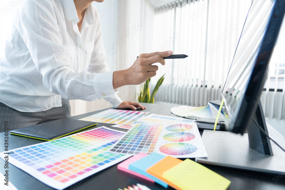 Poster creative graphic designer choosing color scale for editing artwork while working in office.