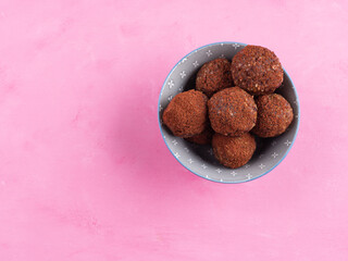 Healthy vegan energy protein balls with nut butter, dried fruit, oats and seeds. Cocoa flavour