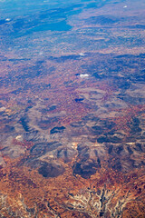 Fototapeta na wymiar mountain landscape view from airplane window, vertical