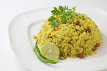 Indian Breakfast Dish Poha Also Know as Pohe or Aalu poha made up of Beaten Rice or Flattened Rice. The rice flakes are lightly fried in oil with mustard, turmeric, onion, curry leaves
