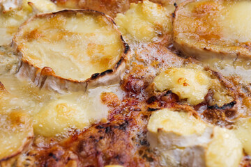 Close-up of pizza topped with goat cheese and caramelized onion. Macro shot of delicious products