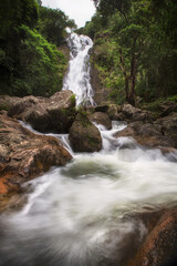 Naklejka premium Beautiful Waterfall in Thailand. River stream flowing over rock formations in the mountains
