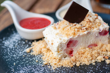 Strawberry cheesecake with crispy crumble and piece of chocolate plate and icing with strawberry...