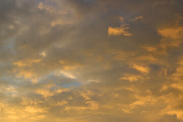 Cloudy sky at sunset on a spring evening as a background.