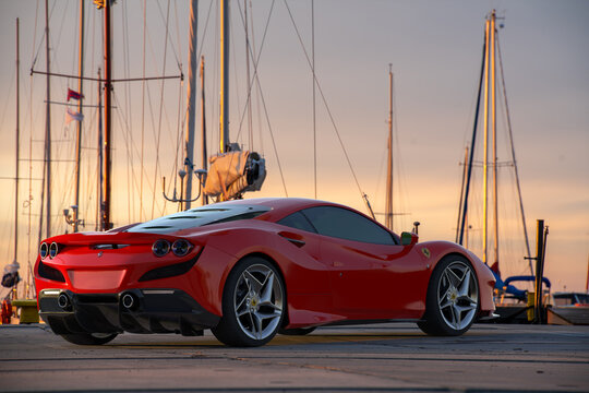 Red Ferrari f8 Tributo in the marina parking lot