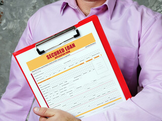Business concept about SECURED LOAN Application Form with sign on bank form.