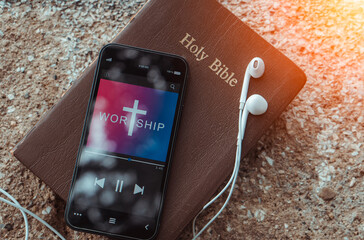 bible with phone and headphones,Concept listen worship song. - obrazy, fototapety, plakaty