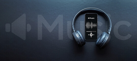 Music banner. Mobile smartphone screen with music application, sound headphones. Audio voice with radio beats on black background. Broadcast media music banner with copy space.