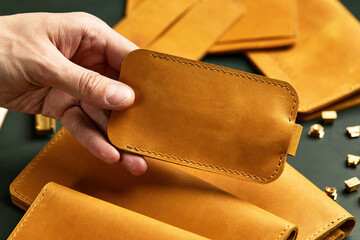Handmade leather goods, close-up. Space for the text, the master jerks a leather block in his hands...